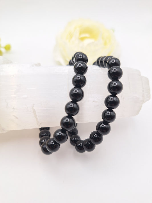 8mm black obsidian bracelet made from genuine volcanic glass. A powerful grounding and protection stone, promoting creativity and Root Chakra balance. Stretchy, unisex design.