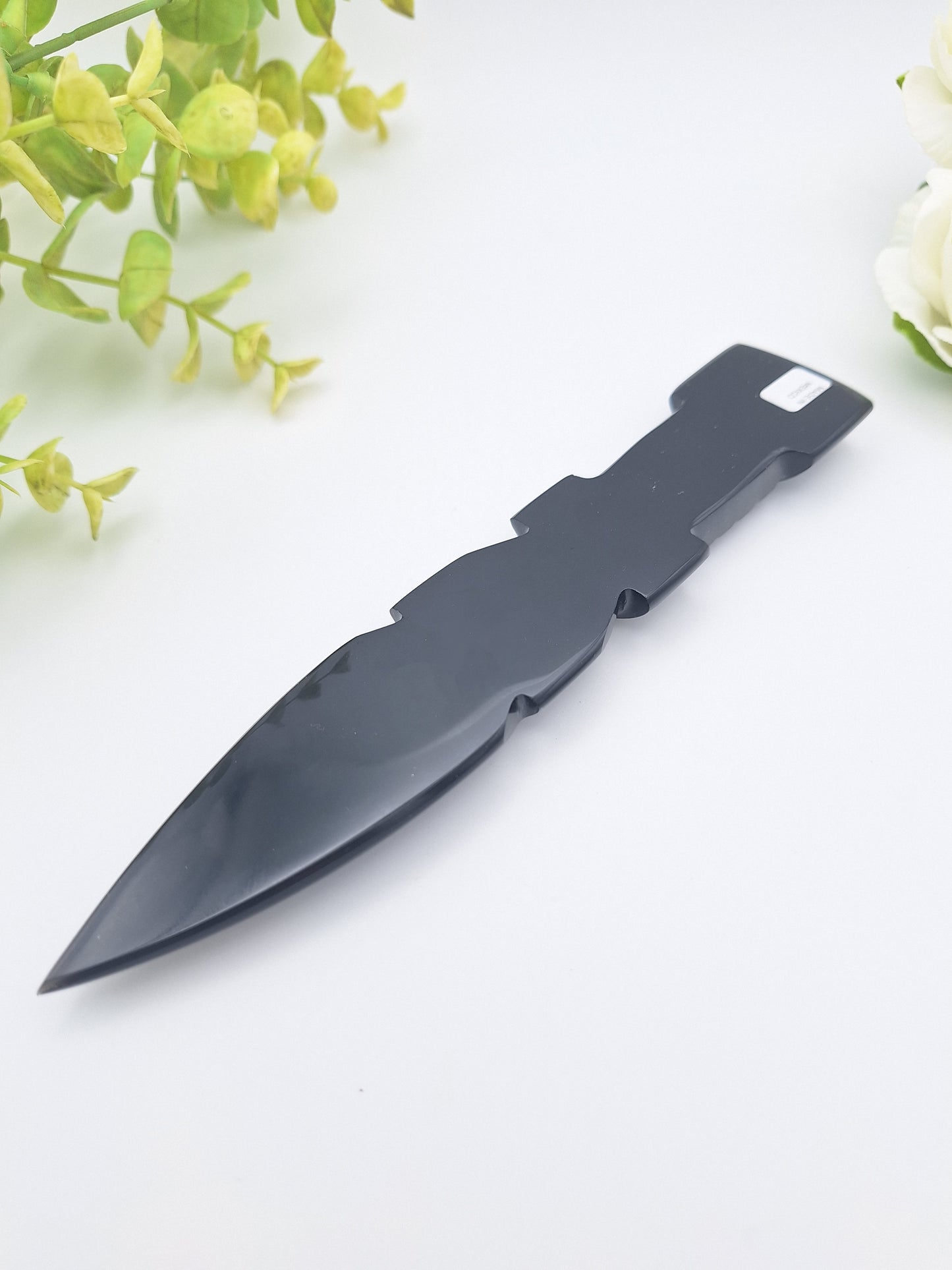 Flat backside of the Black Obsidian dagger, showcasing its smooth, polished surface and fine carving details."