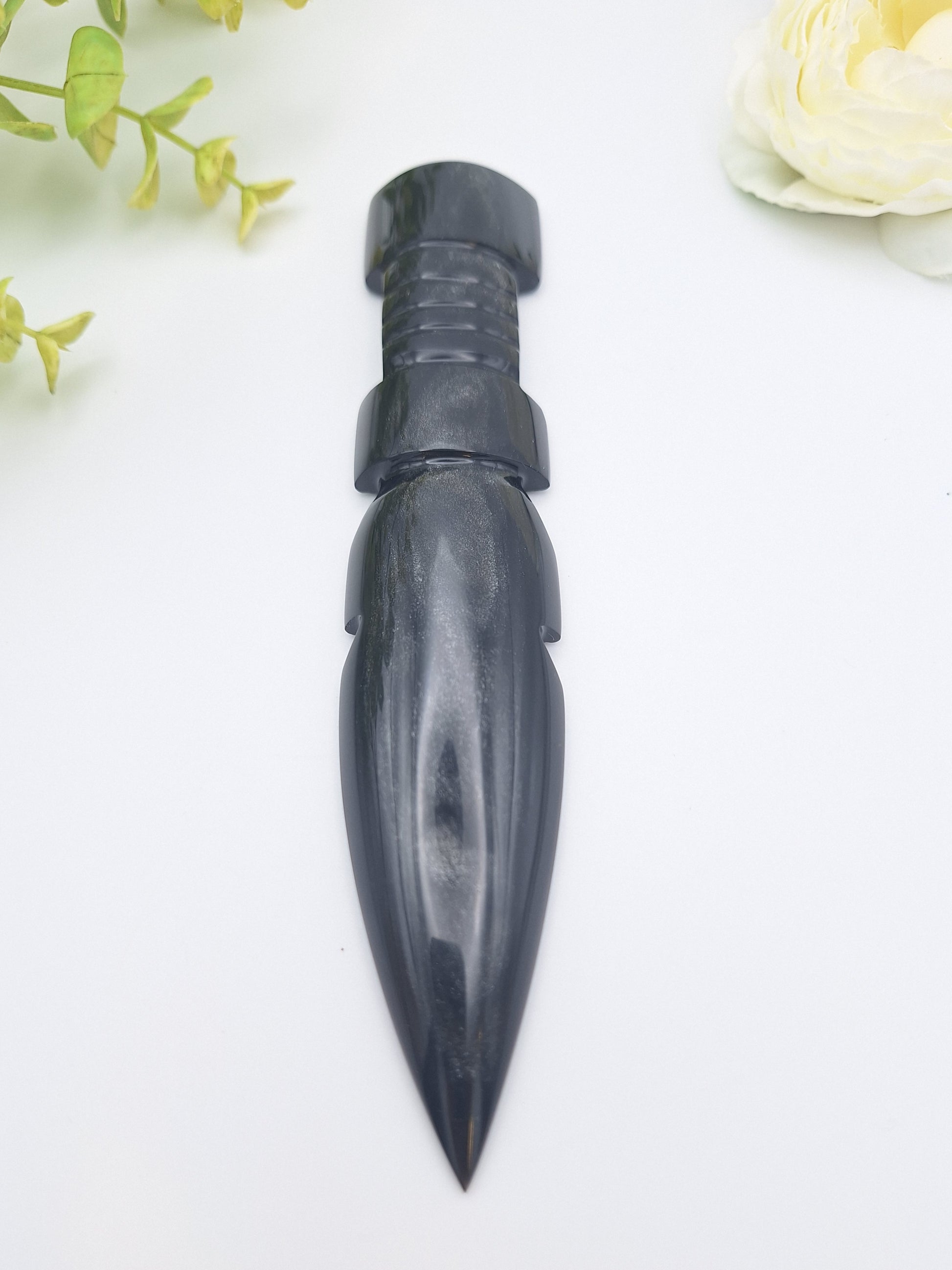Black Obsidian dagger positioned with its sharp point facing forward, showcasing its sleek, glossy blade and fine craftsmanship.