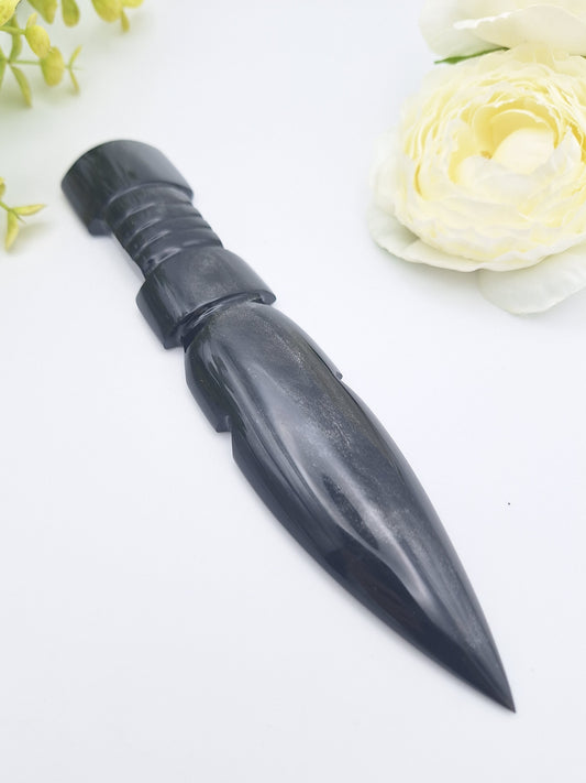 Black Obsidian carved dagger displayed at a left angle with a delicate flower, highlighting its polished blade and smooth handle.