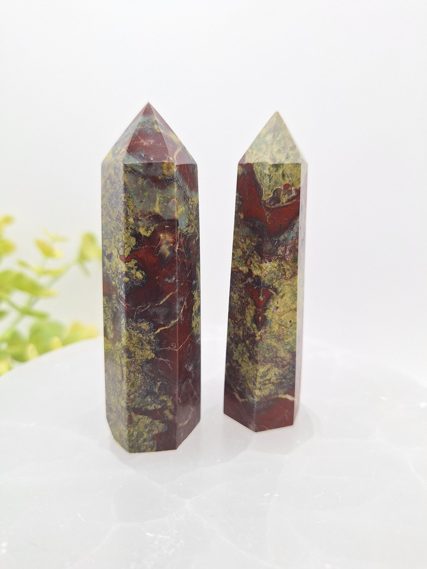 Two standing Dragon Bloodstone crystal towers with deep green and red hues. Made from natural Epidote and Piemontite, these polished points are valued for strength, courage, and energy work.
