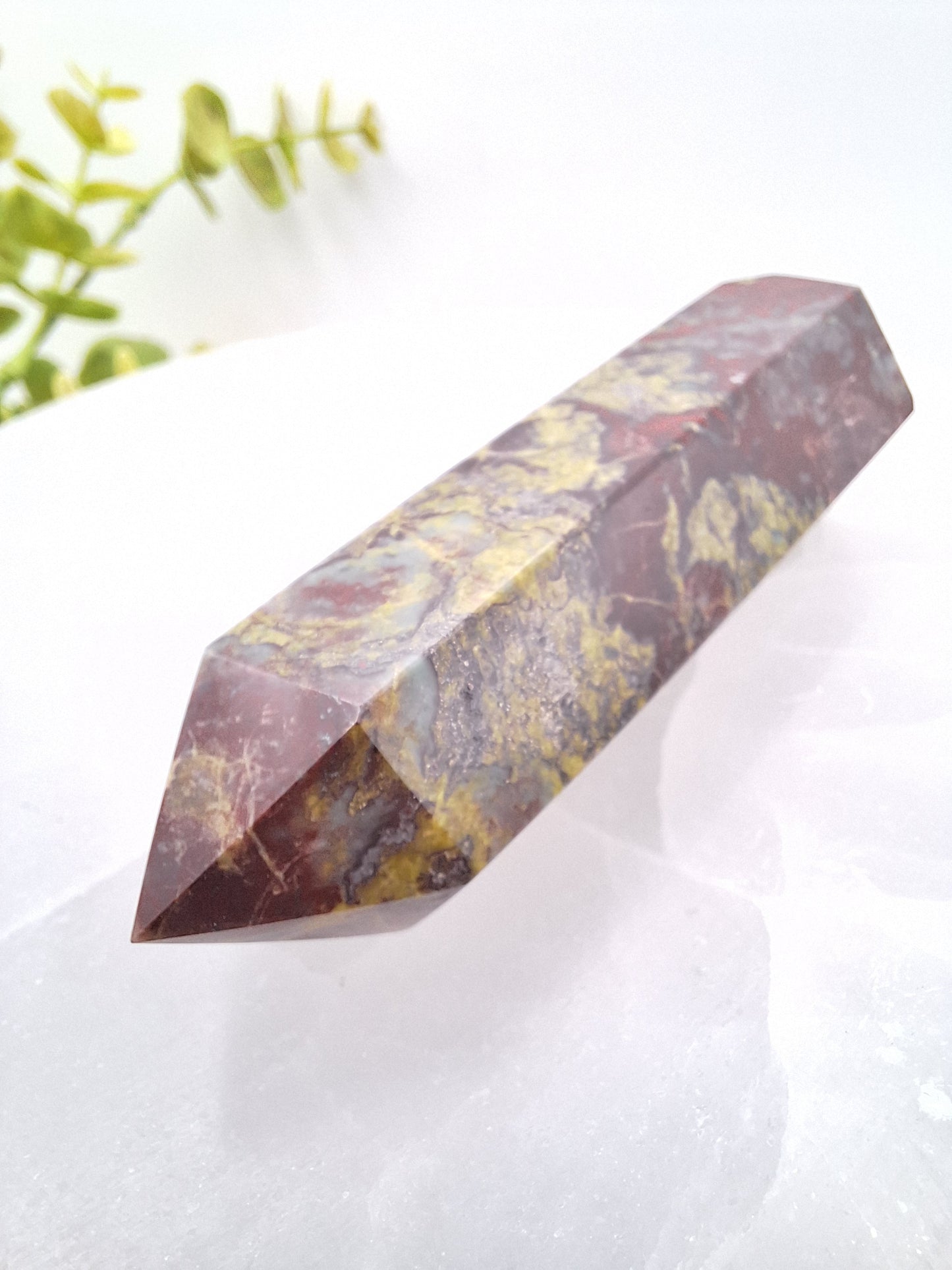 Side view of a Dragon Bloodstone tower showcasing its polished surface and natural red and green mineral patterns. A powerful stone for focus, grounding, and manifestation.