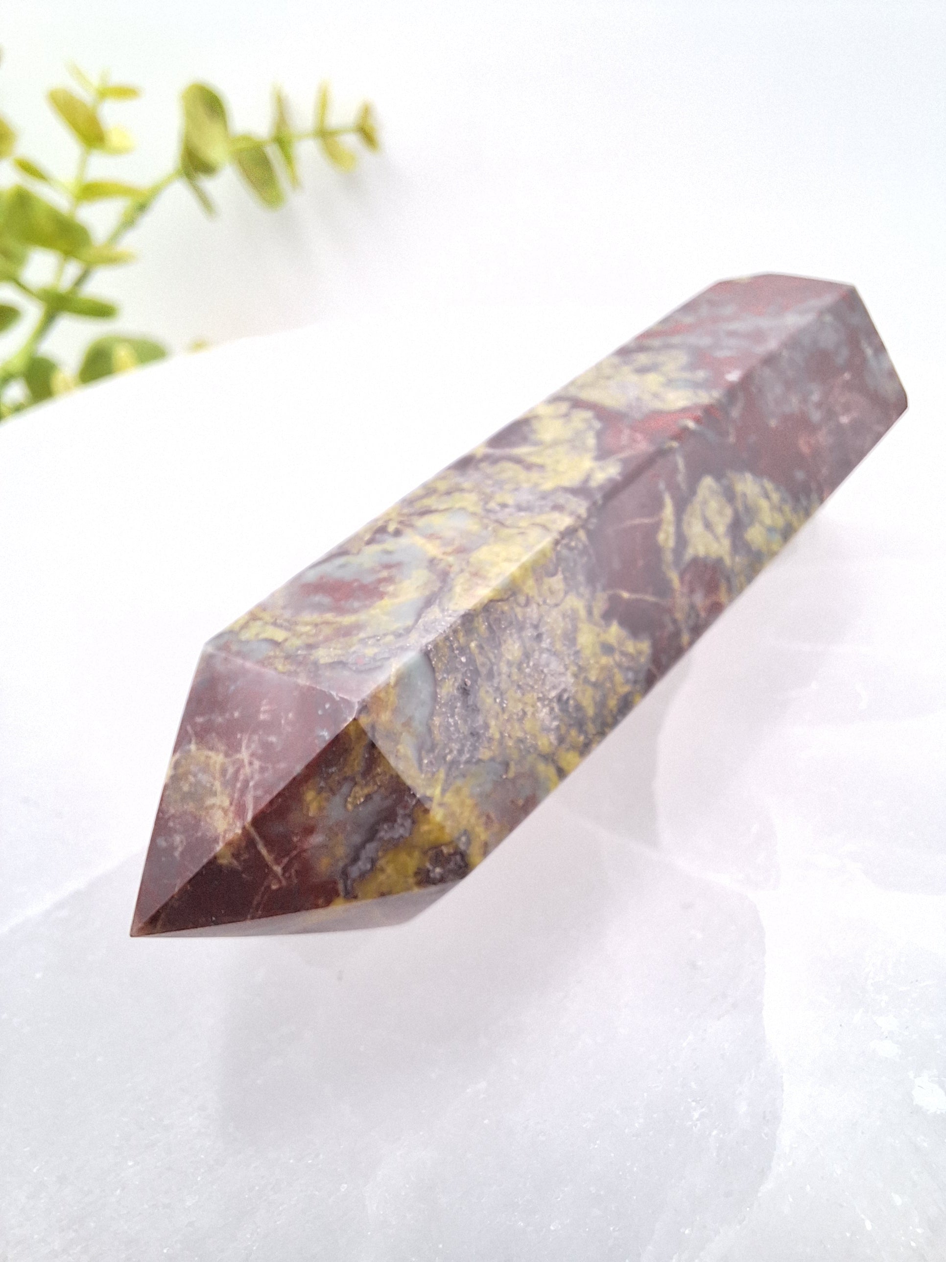 Side view of a Dragon Bloodstone tower showcasing its polished surface and natural red and green mineral patterns. A powerful stone for focus, grounding, and manifestation.