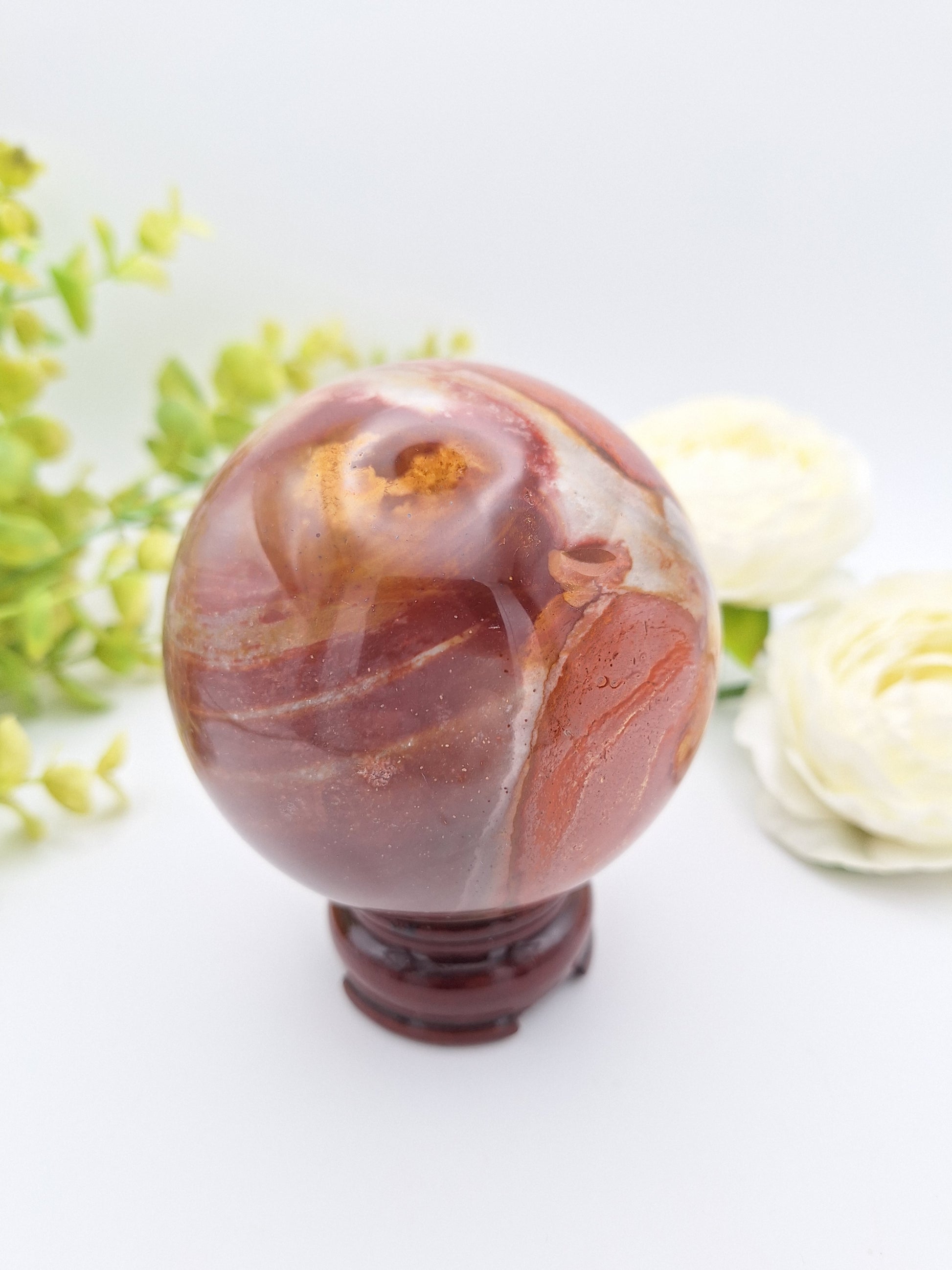 Opposite side of a Polychrome Jasper sphere, displaying its natural variations and bold earth-tone markings.