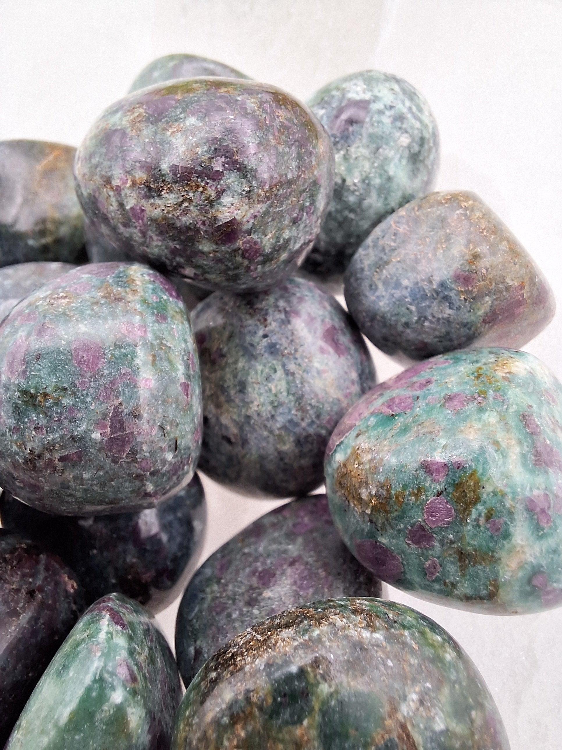 Detailed view of a Ruby Kyanite tumbled stone, showing the natural blend of rich blue and deep red minerals.