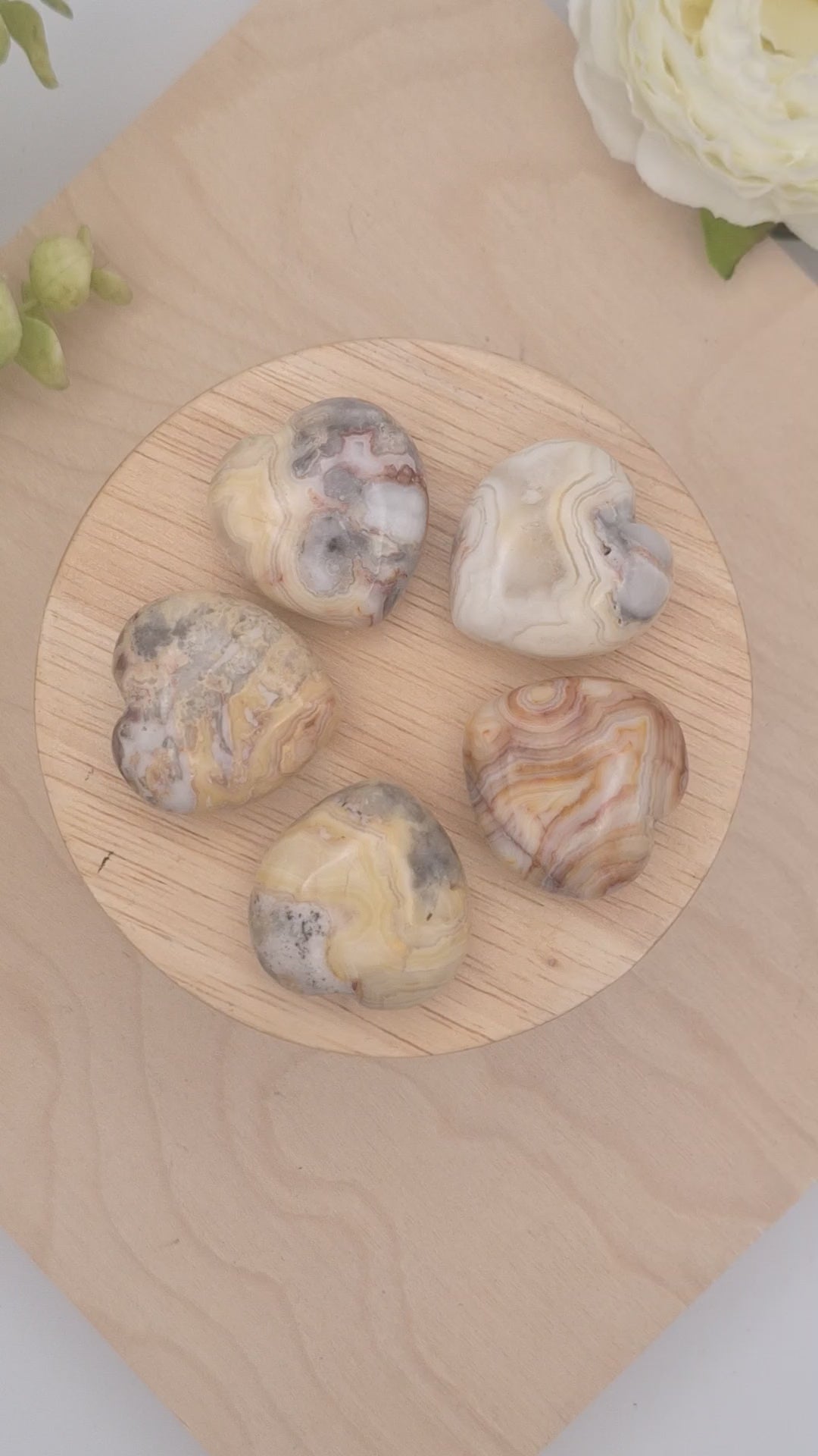 Yellow Crazy Lace Agate hearts on a slowly spinning display showcasing beautiful banding and colors 